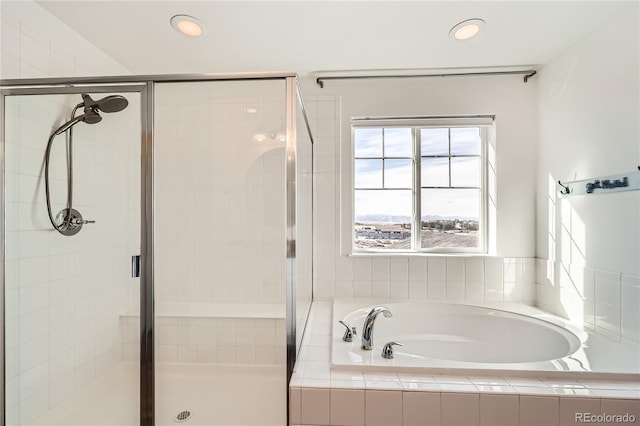 bathroom featuring separate shower and tub