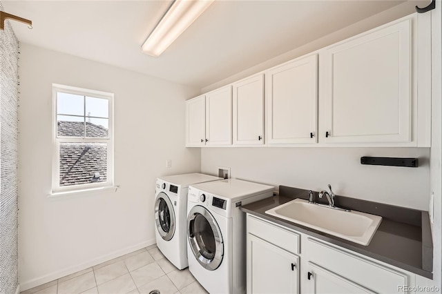 laundry room with cabinets, sink, washer and dryer, and light tile patterned floors