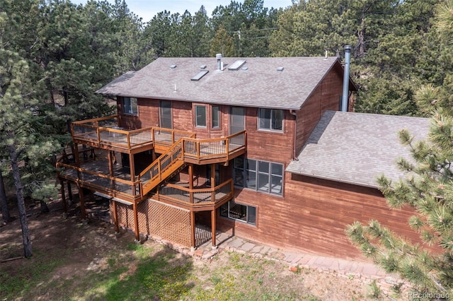 133 Mine Ln, Boulder, CO 80302 - back of house featuring roof with shingles, a wooden deck, and a view of trees