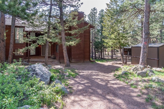 133 Mine Ln, Boulder, CO 80302 - view of side of property with a chimney and an outdoor structure
