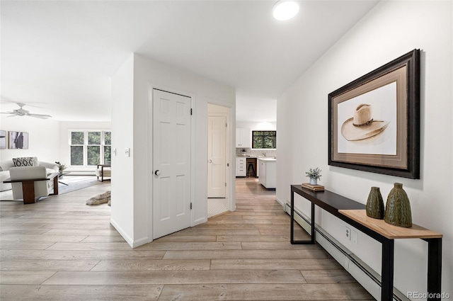 133 Mine Ln, Boulder, CO 80302 - corridor with light wood finished floors, healthy amount of natural light, and baseboard heating