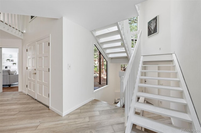 133 Mine Ln, Boulder, CO 80302 - staircase with wood finished floors and a baseboard radiator