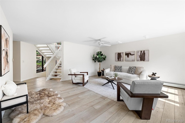 133 Mine Ln, Boulder, CO 80302 - living room featuring stairs, light wood-type flooring, a baseboard heating unit, and a ceiling fan