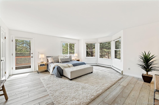 133 Mine Ln, Boulder, CO 80302 - bedroom featuring access to exterior, multiple windows, light wood-style floors, and a baseboard radiator