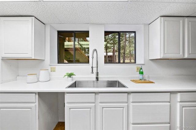 133 Mine Ln, Boulder, CO 80302 - kitchen featuring white cabinetry, light countertops, and a paneled ceiling