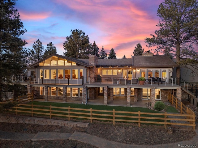 back house at dusk with a patio