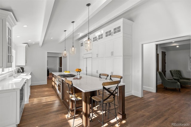 dining space featuring lofted ceiling with beams, dark hardwood / wood-style floors, and sink