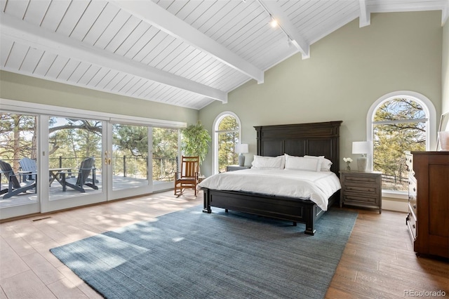 bedroom featuring high vaulted ceiling, beam ceiling, hardwood / wood-style floors, and access to outside