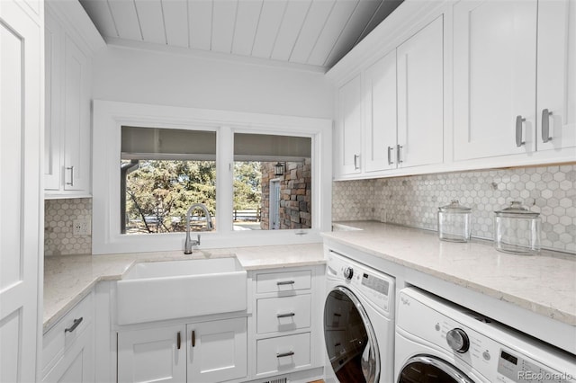 laundry room featuring sink, wooden ceiling, cabinets, and washing machine and clothes dryer