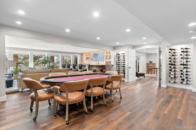 dining area featuring hardwood / wood-style floors and bar area