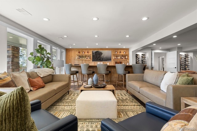 living room featuring hardwood / wood-style floors and bar area