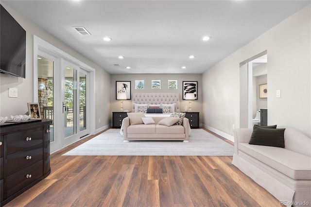 bedroom featuring wood-type flooring and access to outside