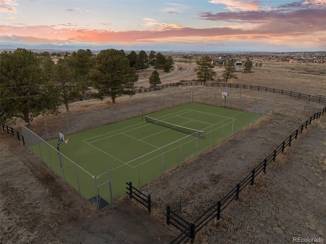 view of tennis court featuring a rural view