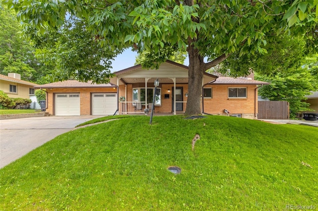 2876 S Wolff St, Denver, CO 80236 - ranch-style house featuring brick siding, concrete driveway, a porch, and a garage