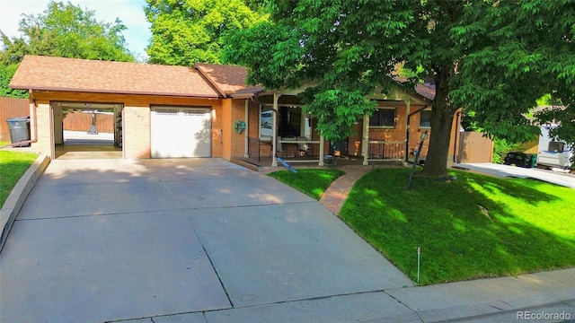 2876 S Wolff St, Denver, CO 80236 - ranch-style home with driveway, an attached garage, a front lawn, and brick siding