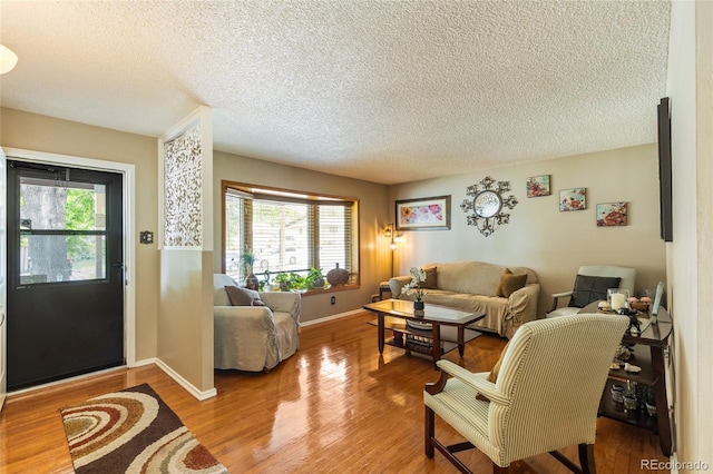 2876 S Wolff St, Denver, CO 80236 - living room featuring a textured ceiling and wood finished floors