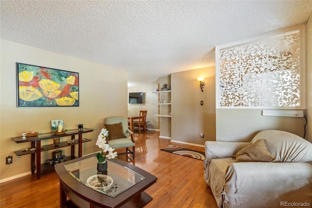 2876 S Wolff St, Denver, CO 80236 - living area featuring a textured ceiling and wood finished floors