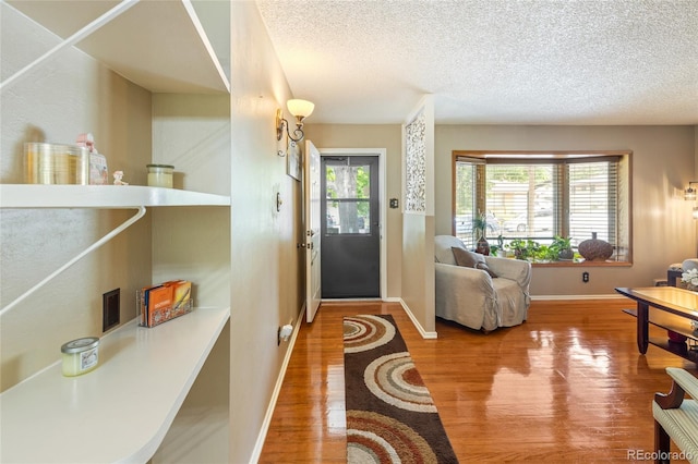 2876 S Wolff St, Denver, CO 80236 - entryway featuring wood finished floors and a textured ceiling
