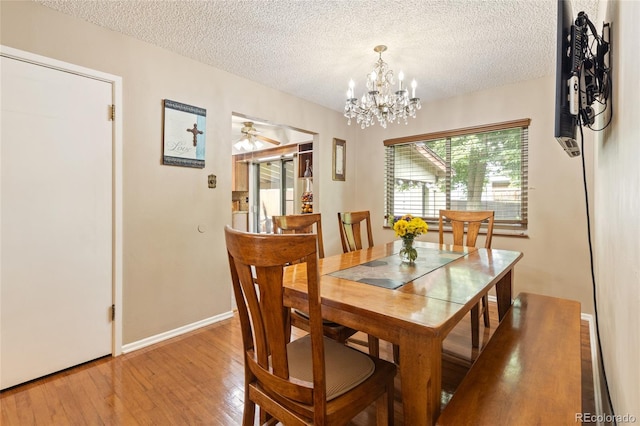 2876 S Wolff St, Denver, CO 80236 - dining area featuring hardwood / wood-style floors, a textured ceiling, a chandelier, and a ceiling fan