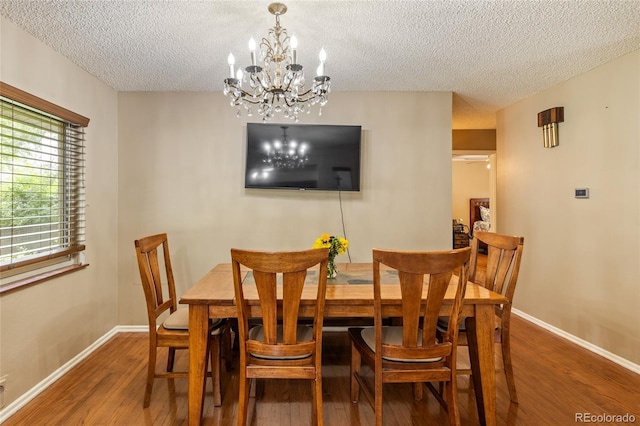 2876 S Wolff St, Denver, CO 80236 - dining room featuring a textured ceiling, a chandelier, and wood finished floors