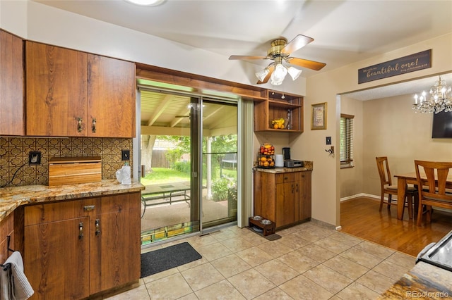 2876 S Wolff St, Denver, CO 80236 - kitchen featuring plenty of natural light, brown cabinets, light tile patterned floors, and ceiling fan