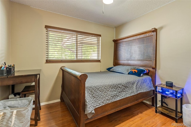2876 S Wolff St, Denver, CO 80236 - bedroom with wood finished floors and a textured ceiling