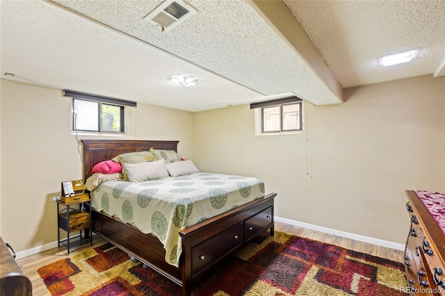 2876 S Wolff St, Denver, CO 80236 - bedroom featuring a textured ceiling and wood finished floors