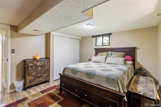 2876 S Wolff St, Denver, CO 80236 - bedroom featuring wood finished floors, a textured ceiling, and a closet