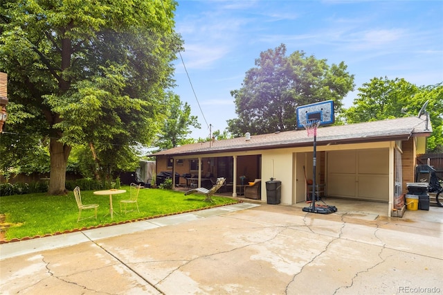 2876 S Wolff St, Denver, CO 80236 - view of front of property featuring a garage, a patio, and concrete driveway