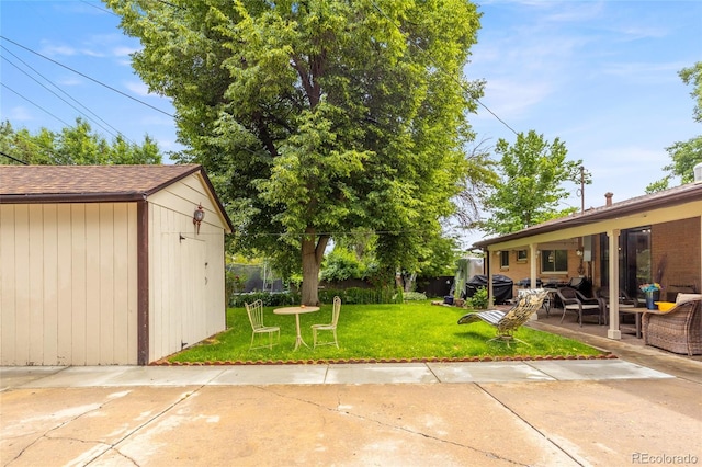 2876 S Wolff St, Denver, CO 80236 - view of grassy yard featuring a patio area, outdoor lounge area, and a storage shed