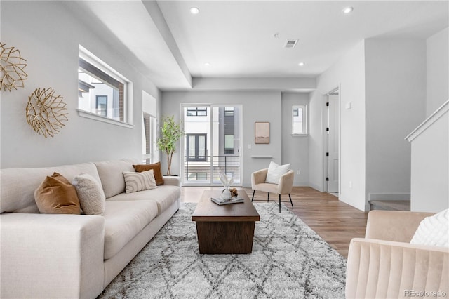 living area with wood finished floors and recessed lighting