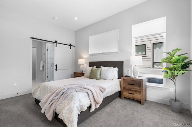 bedroom featuring a barn door, light carpet, and baseboards