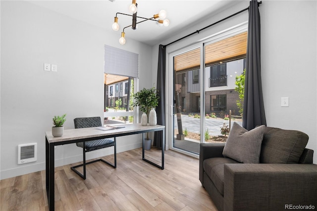 office featuring light wood finished floors and a chandelier