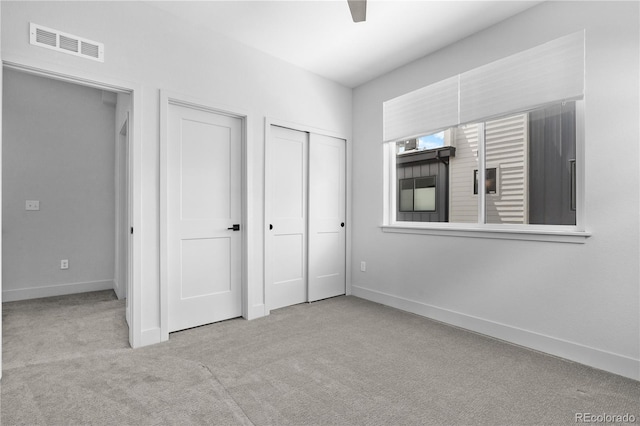 unfurnished bedroom with carpet, baseboards, and ceiling fan