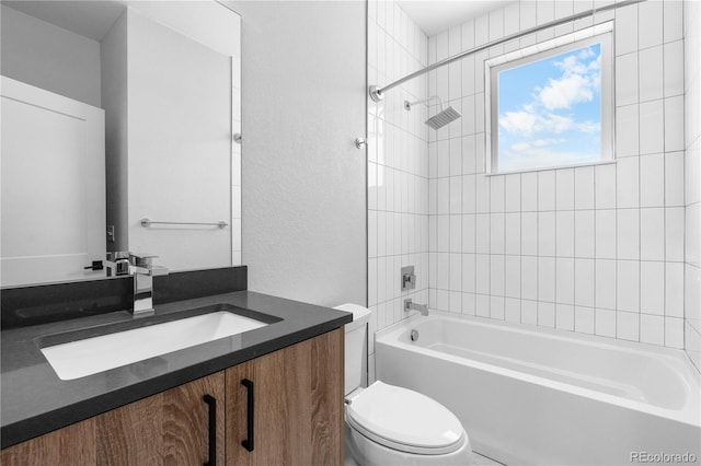 full bath with toilet, tub / shower combination, vanity, and a textured wall