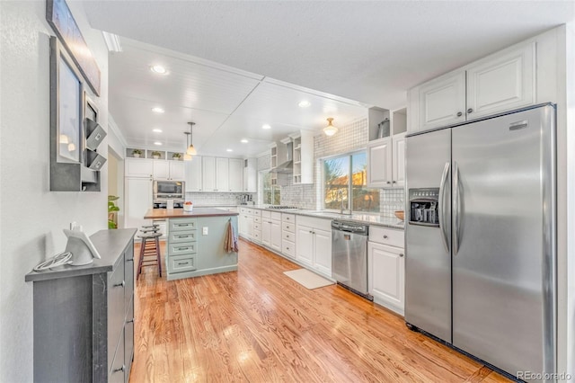 kitchen with white cabinetry, appliances with stainless steel finishes, and a kitchen island