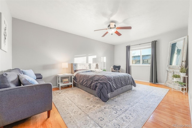 bedroom with ceiling fan and hardwood / wood-style floors