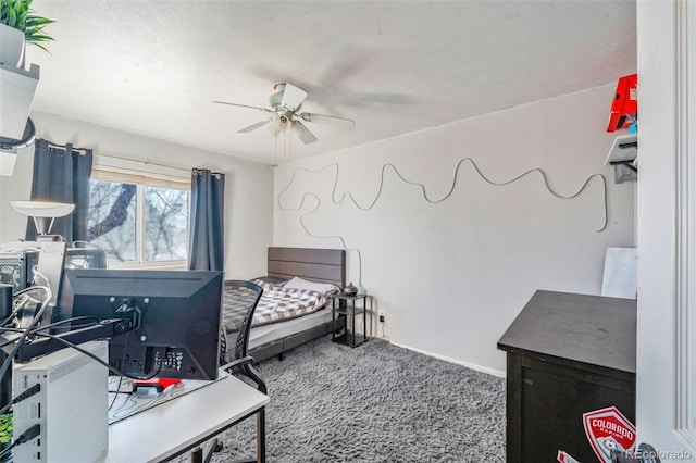 carpeted bedroom with a textured ceiling and ceiling fan