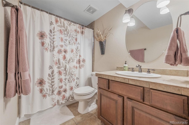 bathroom with vanity, toilet, tile patterned floors, and a shower with shower curtain