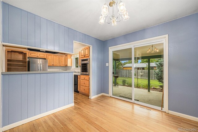 5502 E Center Ave, Denver, CO 80246 - kitchen featuring stainless steel appliances, a chandelier, light wood finished floors, light countertops, and a peninsula