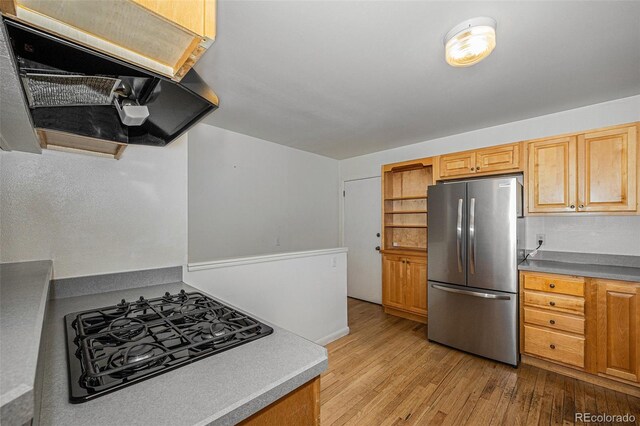 5502 E Center Ave, Denver, CO 80246 - kitchen featuring freestanding refrigerator, exhaust hood, cooktop, and light wood-style floors