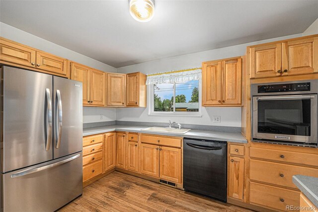5502 E Center Ave, Denver, CO 80246 - kitchen with appliances with stainless steel finishes, wood finished floors, and light countertops