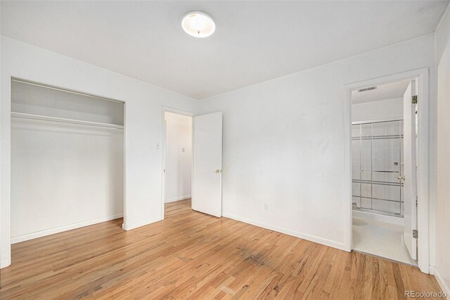 5502 E Center Ave, Denver, CO 80246 - unfurnished bedroom featuring light wood finished floors, a closet, and ensuite bathroom