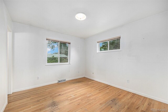 5502 E Center Ave, Denver, CO 80246 - spare room featuring baseboards and light wood-style floors
