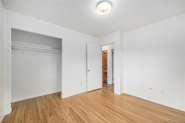 5502 E Center Ave, Denver, CO 80246 - unfurnished bedroom featuring light wood-style floors and a closet