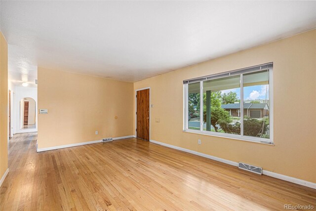 5502 E Center Ave, Denver, CO 80246 - unfurnished room with light wood finished floors and arched walkways