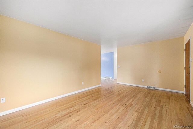 5502 E Center Ave, Denver, CO 80246 - empty room with light wood-style flooring and baseboards