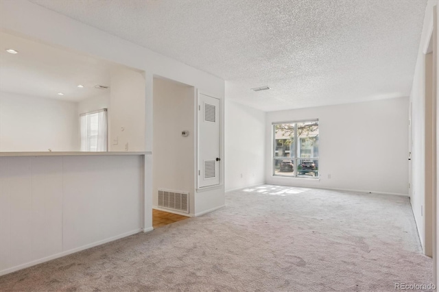 7275 S Gaylord St Unit I09, Littleton, CO 80122 - carpeted spare room featuring healthy amount of natural light, baseboards, a textured ceiling, and recessed lighting