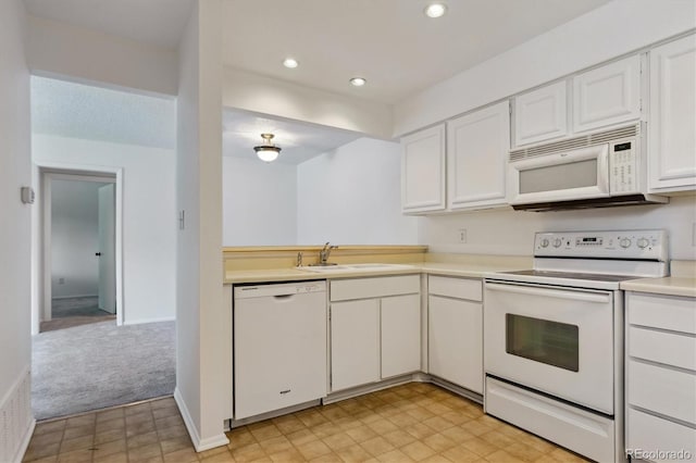 7275 S Gaylord St Unit I09, Littleton, CO 80122 - kitchen with white appliances, a sink, light countertops, white cabinetry, and recessed lighting