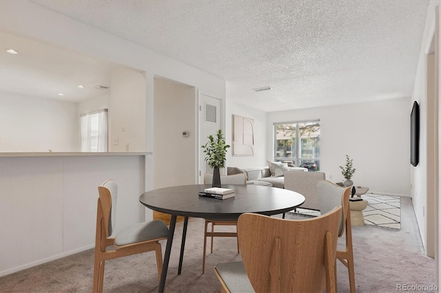 7275 S Gaylord St Unit I09, Littleton, CO 80122 - carpeted dining room featuring healthy amount of natural light, a textured ceiling, baseboards, and recessed lighting